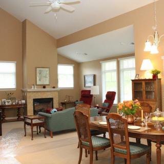 A spacious open-concept living and dining area with warm lighting and comfortable furniture.