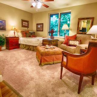 A cozy living room featuring warm lighting, comfortable furniture, and tasteful decor.