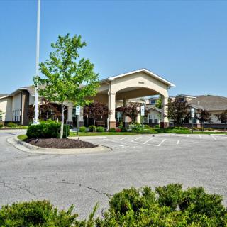 A suburban building with an entrance, set against a clear blue sky.