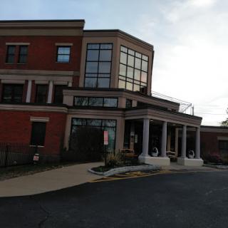 A modern brick building with large windows and an inviting entrance.