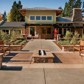 A modern home with an inviting outdoor patio and landscaped garden.