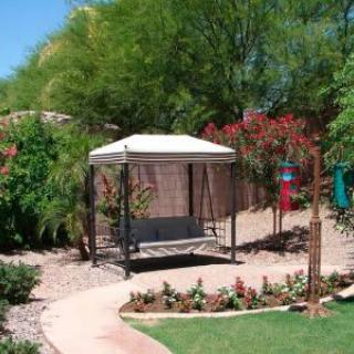 A serene garden with a gazebo surrounded by lush greenery and a winding pathway.