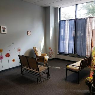 A cozy waiting room with chairs and decorative elements.