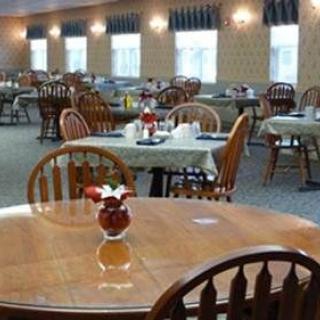 An empty dining room with neatly arranged tables and chairs.
