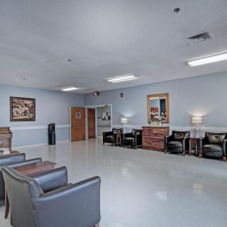 A spacious and bright waiting room with comfortable seating and decorative elements.