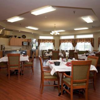 An elegantly arranged dining room with neatly set tables and chairs.