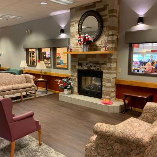 A cozy living room with a fireplace and comfortable seating.