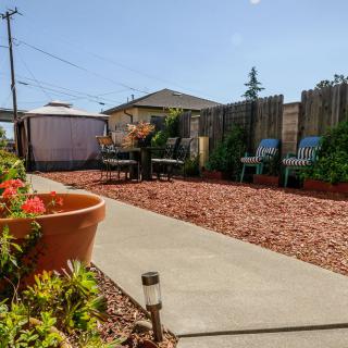 A well-maintained backyard with a patio area, outdoor seating, and vibrant landscaping.