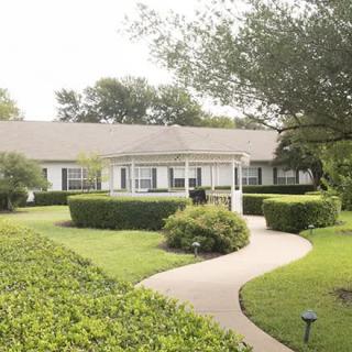 A charming house with a landscaped garden and winding pathway.