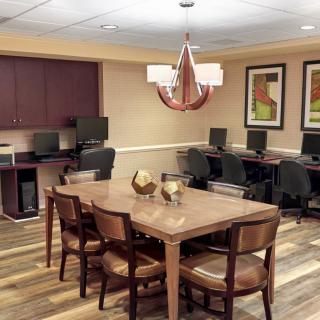 Modern office conference room with computers and a central table.