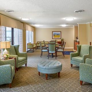 A cozy living room with comfortable seating and large windows.