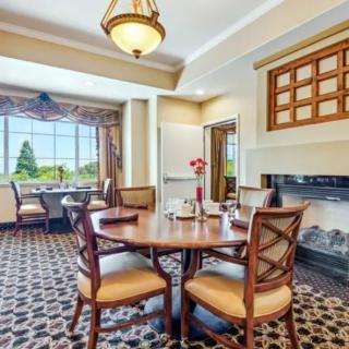 A well-appointed dining room with elegant furnishings and a fireplace.