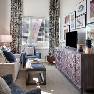 A stylish living room featuring modern furniture and decorative wall art.