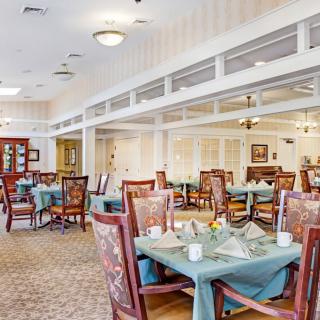 A well-decorated dining area with neatly arranged tables and chairs.