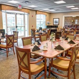 A well-arranged dining area with neatly set tables and comfortable seating.