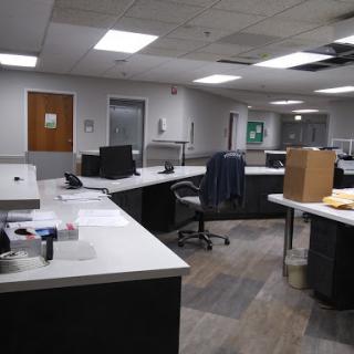 An empty office space showcasing modern workstations and a clean, organized layout.