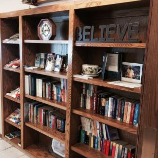 A neatly arranged wooden bookshelf filled with books and decorative items.