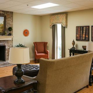 A cozy and inviting living room featuring a fireplace, comfortable seating, and tasteful decor.