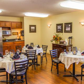 An elegantly arranged dining area with tables set for a meal, showcasing inviting decor.