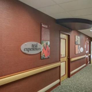 A hallway with artwork and signage on the walls.