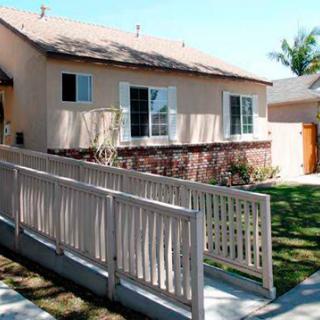 A residential house featuring an accessibility ramp leading to the entrance.