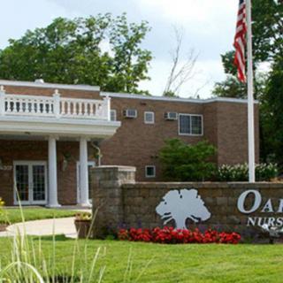 Entrance to a nursing home with a welcoming sign and well-maintained landscaping.