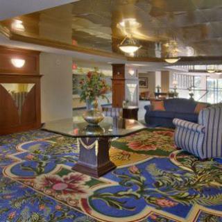 Elegant hotel lobby with floral carpet and comfortable seating.