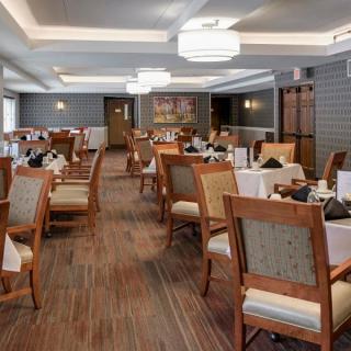 An elegantly designed restaurant dining room with neatly arranged tables and chairs.