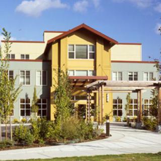 A modern residential building with landscaped surroundings.