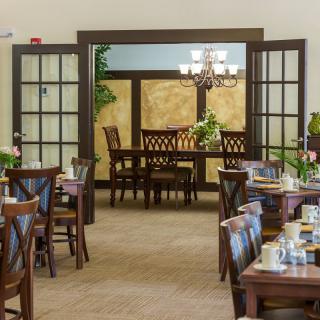 A beautifully arranged dining area with wooden furniture and elegant lighting.