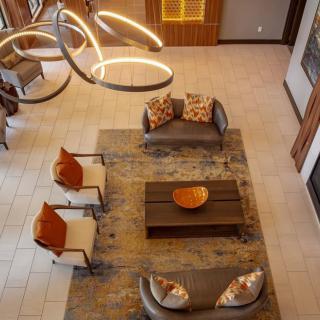A modern living room with stylish furniture and lighting, viewed from above.