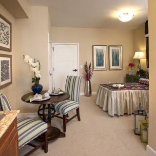 A cozy living room with elegant furniture and decorative artwork on the walls.