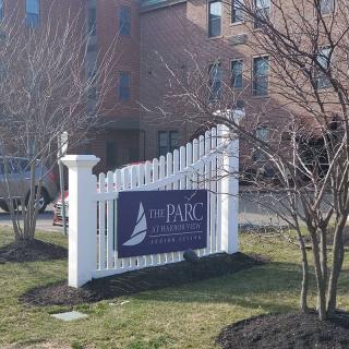 The image shows a sign for a real estate property named 'The Parc on Plymouth'.