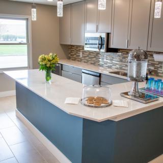 A modern kitchen with a sleek island, contemporary cabinets, and decorative elements.