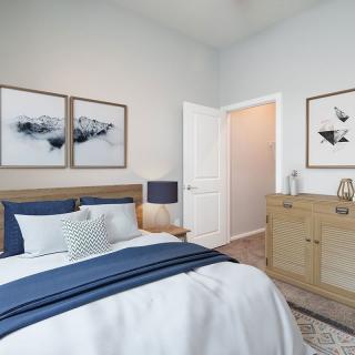A modern bedroom with a bed, stylish decor, and artwork on the walls.