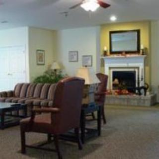 A cozy living room featuring a fireplace, comfortable seating, and elegant decor.