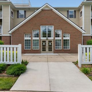 A residential building with a brick facade and a central entrance.