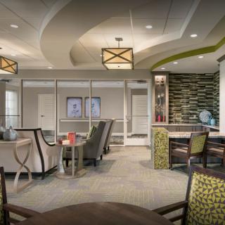 A modern lounge with comfortable seating and warm lighting.