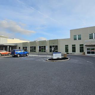 A modern healthcare facility with a spacious parking lot.
