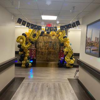 A festive entrance decorated with balloons and a banner to celebrate the arrival of the new year, 2022.