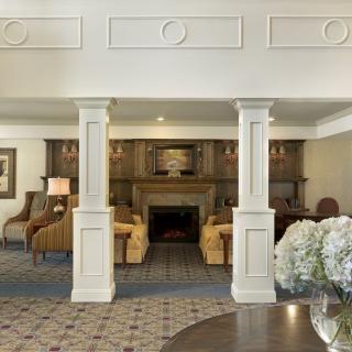A spacious living room featuring a fireplace, comfortable seating, and elegant decor.