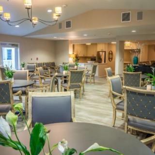 A spacious and well-lit dining area with neatly arranged tables and chairs.