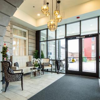 A modern lobby with elegant seating and chandeliers.