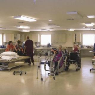 A rehabilitation center with patients receiving physical therapy.