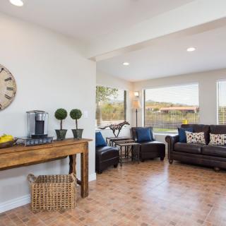A stylish living room with comfortable seating and large windows.