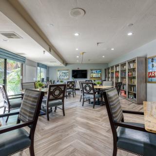 A cozy library with tables and chairs arranged for reading and study.