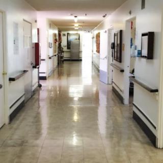 A clean and empty hospital corridor with bright lighting.