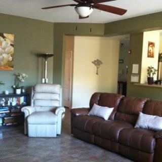 A cozy living room featuring a comfortable sofa, recliner, and tasteful wall art.