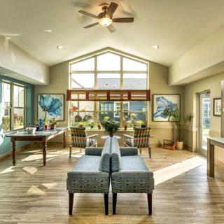 A spacious and modern living room with ample natural light and stylish furnishings.