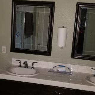 A bathroom with dual sinks and mirrors above a countertop.